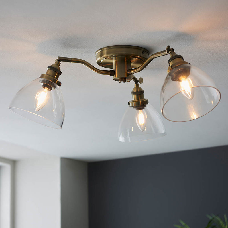 Hansen 3 Light Semi Flush Ceiling Light in antique brass shown in a room setting