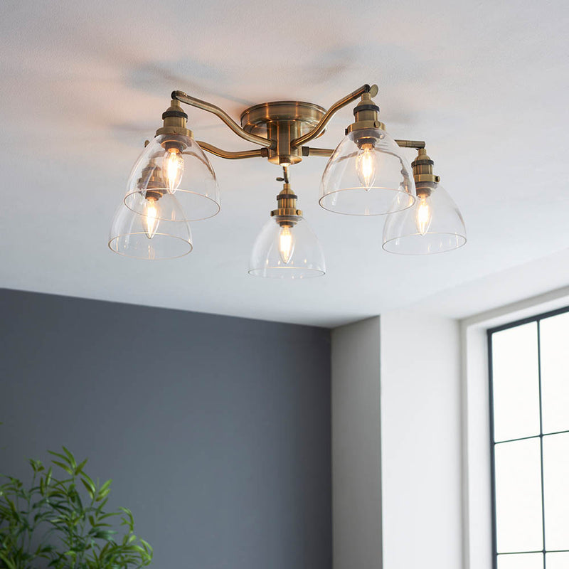 Hansen 5 Light Semi Flush Ceiling Light in antique brass shown in a room setting