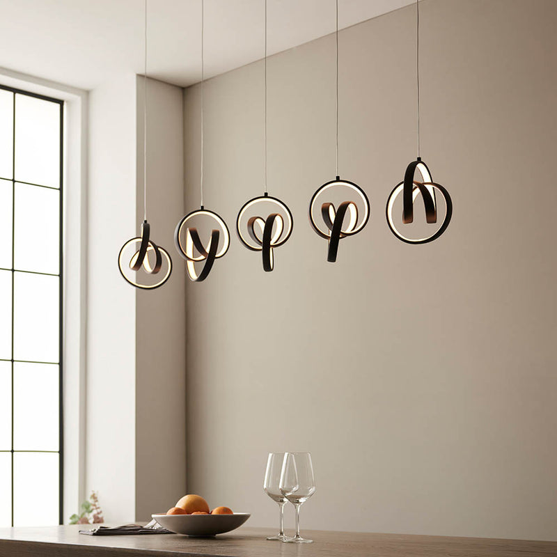 Cosma 5 Light LED Linear Pendant in textured black hanging in a dining room