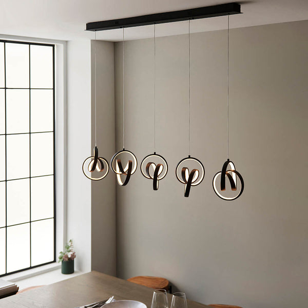 Cosma 5 Light LED Linear Pendant lit up in a styled dining room