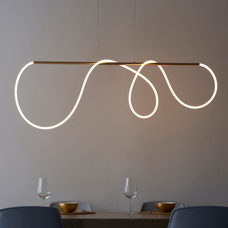 Attalea LED Linear Pendant in satin gold hanging in a dining room