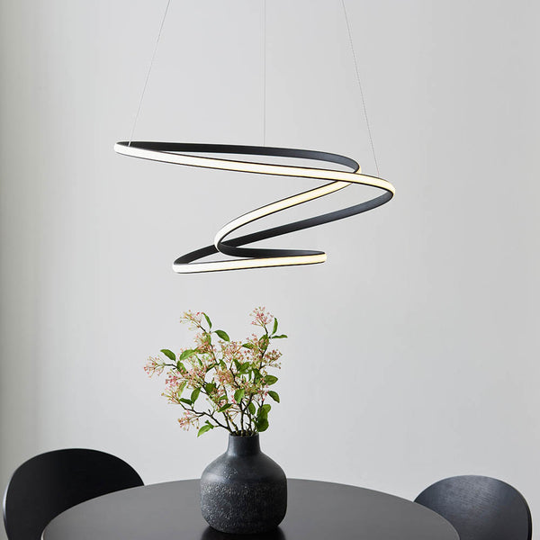 Dune LED Pendant in textured black hanging in a living room