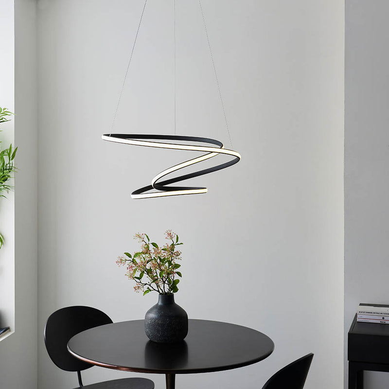 Dune LED Pendant lit up in a styled living room