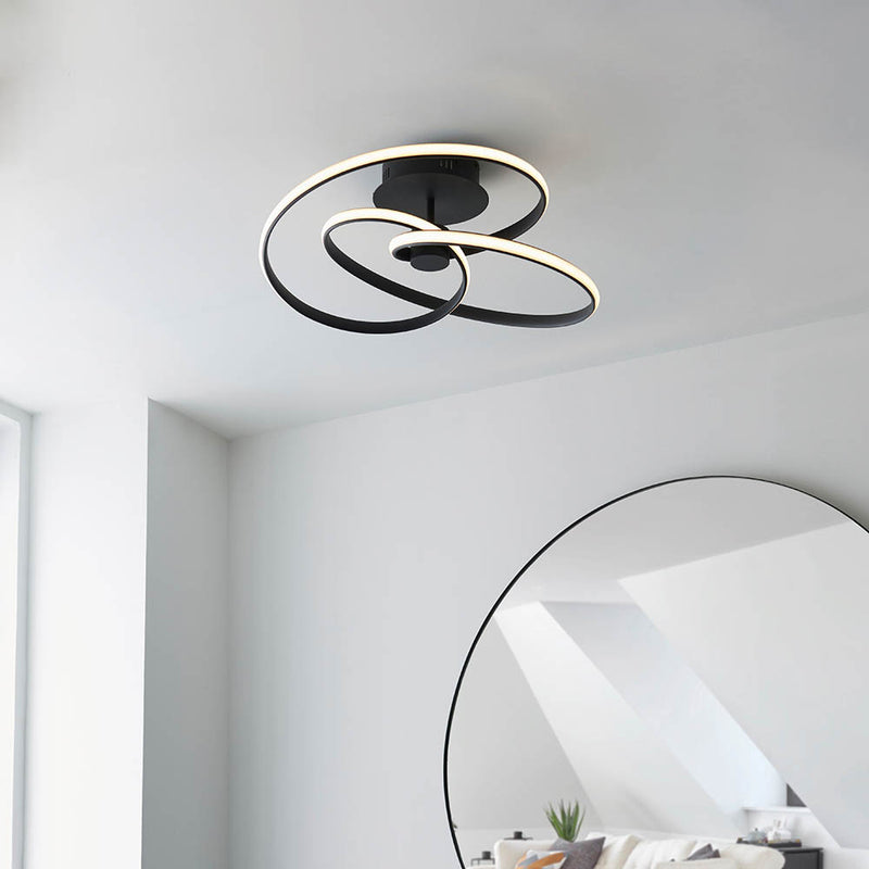Dune LED Semi Flush Ceiling Light lit up in a styled living room