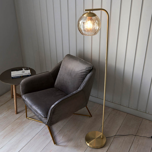 Dimple Floor Lamp lit up in a living room setting