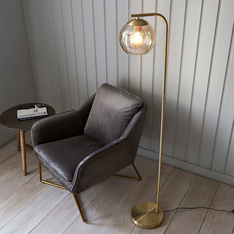Dimple Floor Lamp lit up in a living room setting