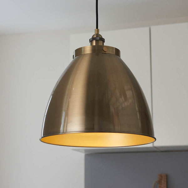 Franklin Large Pendant in antique brass hanging in a kitchen