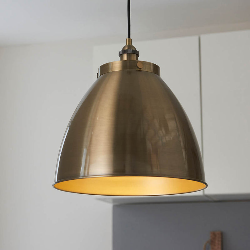 Franklin Large Pendant in antique brass hanging in a kitchen