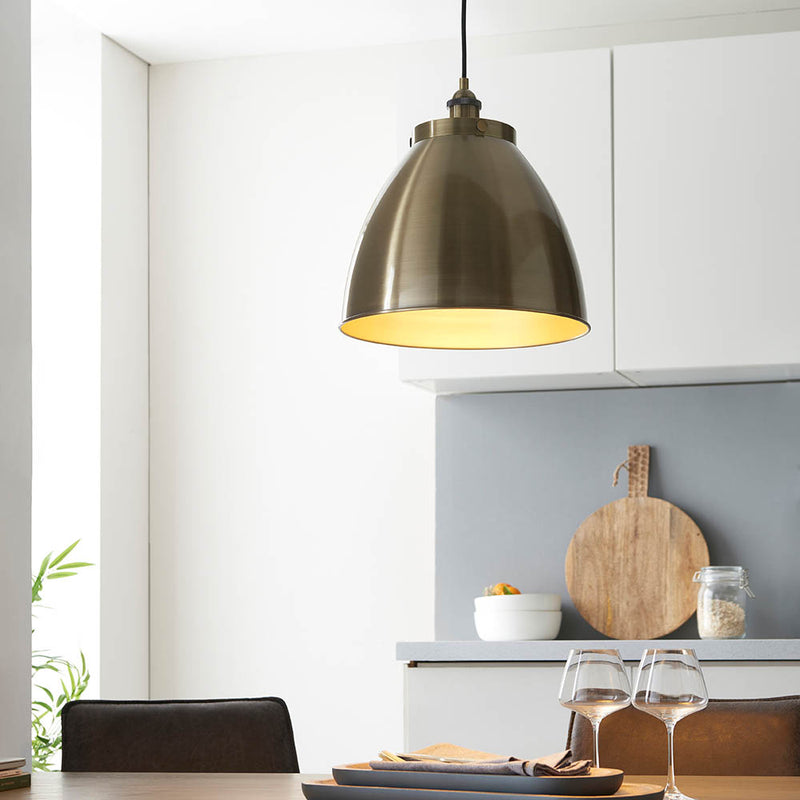 Franklin Large Pendant in antique brass shown in a room setting