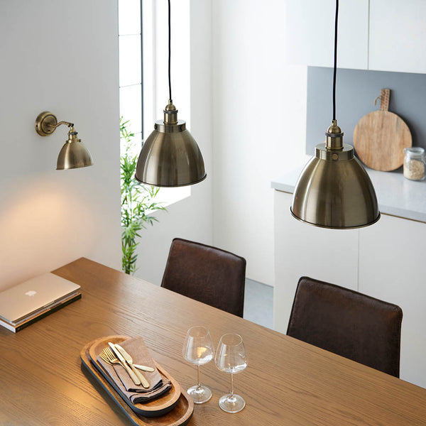 Franklin Small Pendant in antique brass shown in a room setting