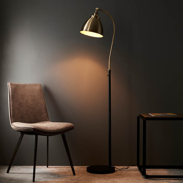 Endon Franklin Task Floor Lamp in antique brass and matt black in a styled living room