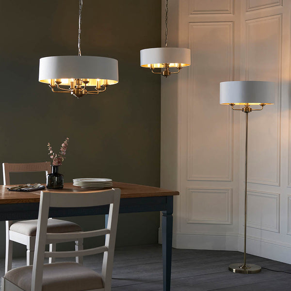 Highclere 3 Light Drum Pendant lit up in a styled bedroom