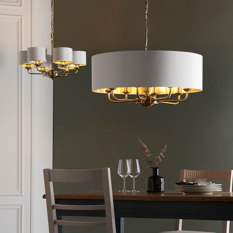 Highclere 8 Light Drum Pendant lit up in a styled living room