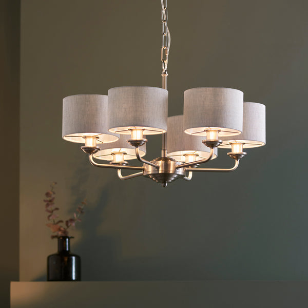 Highclere 6 Light Pendant lit up in a styled living room