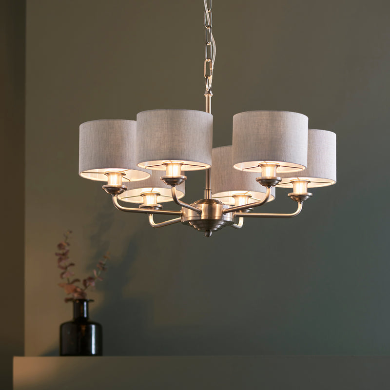 Highclere 6 Light Pendant lit up in a styled living room