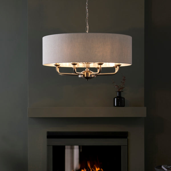 Highclere 8 Light Drum Pendant in brushed chrome hanging in a living room