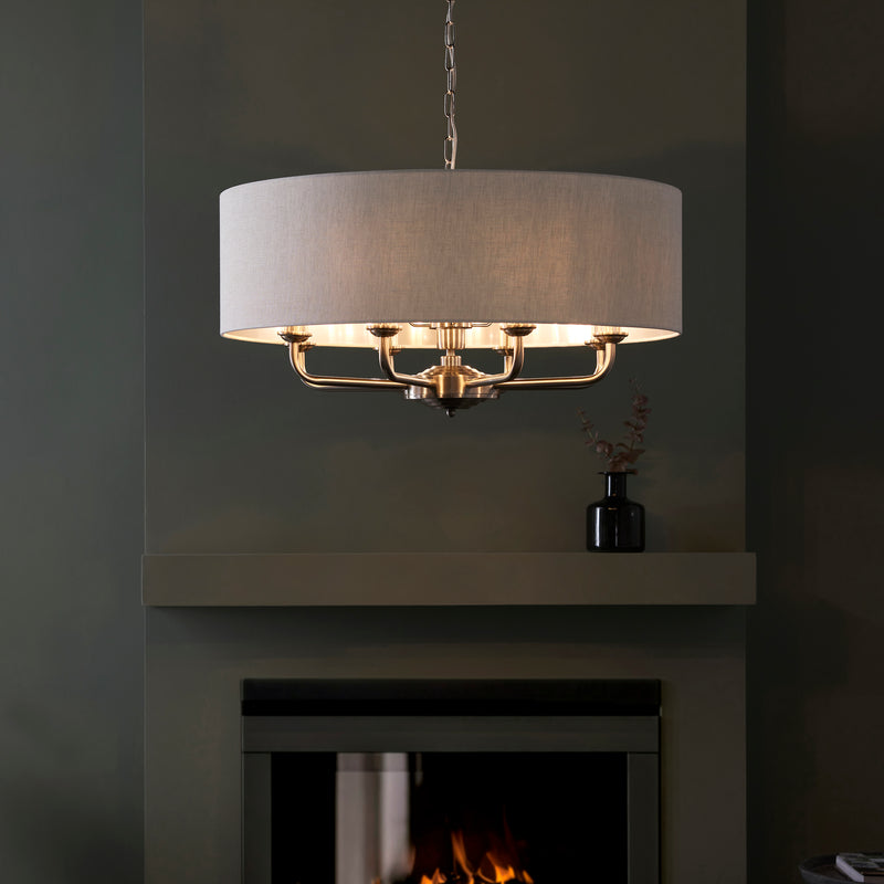 Highclere 8 Light Drum Pendant in brushed chrome hanging in a living room