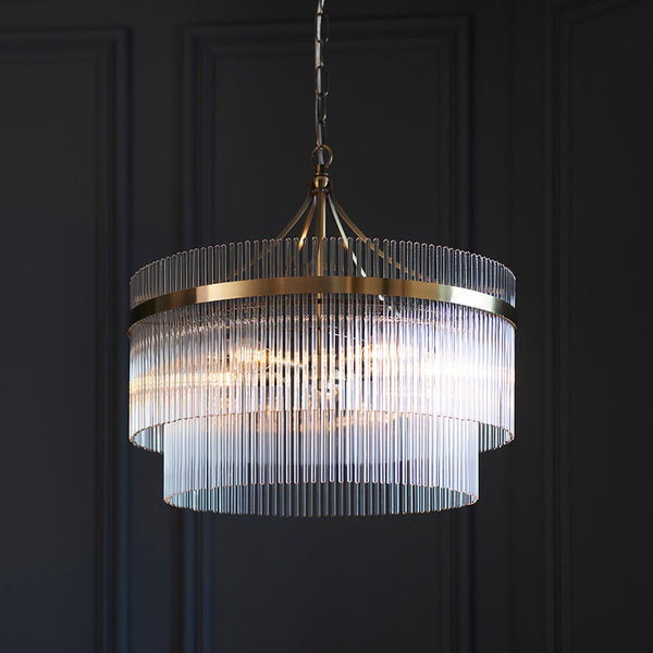 Marietta 5 Light Chandelier in antique brass hanging in a living room