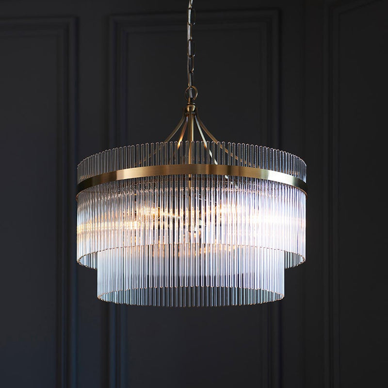 Marietta 5 Light Chandelier in antique brass hanging in a living room