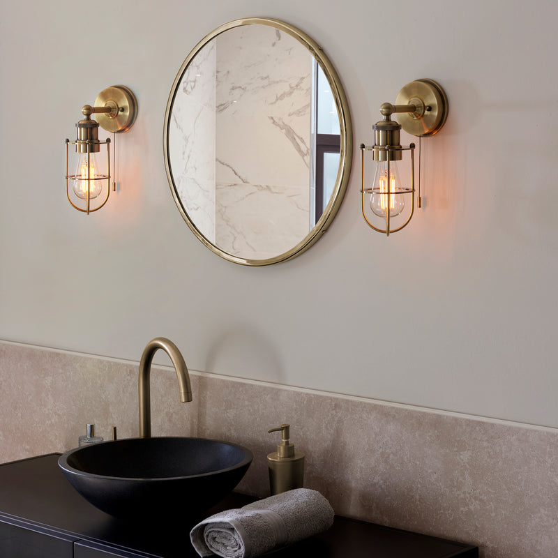 Crew Bathroom Wall Light lit up in a styled bathroom