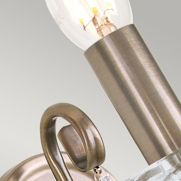 Elstead Aegean 1 Light Wall Light in aged brass, featuring hand-forged scrollwork, cut glass droplets, and a timeless classical design. Ideal for elegant interiors with dimmable functionality.