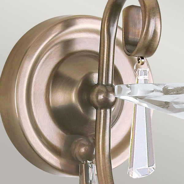 Elstead Aegean 1 Light Wall Light in aged brass, featuring hand-forged scrollwork, cut glass droplets, and a timeless classical design. Ideal for elegant interiors with dimmable functionality.