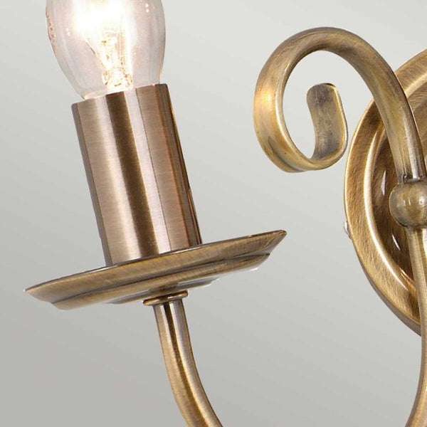 Elstead Artisan 2 Light Wall Light in aged brass, featuring intricate scrollwork, knot twist detailing, and a durable steel build, perfect for traditional interiors.