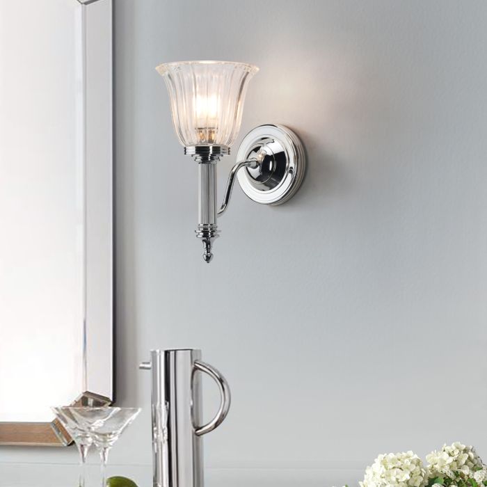 Elstead Carroll 1 Light Wall Light in polished chrome with a solid brass build and sleek finish. IP44-rated for bathroom use, includes a 3W LED G9 bulb. Provides warm 3000K illumination with a stylish design.