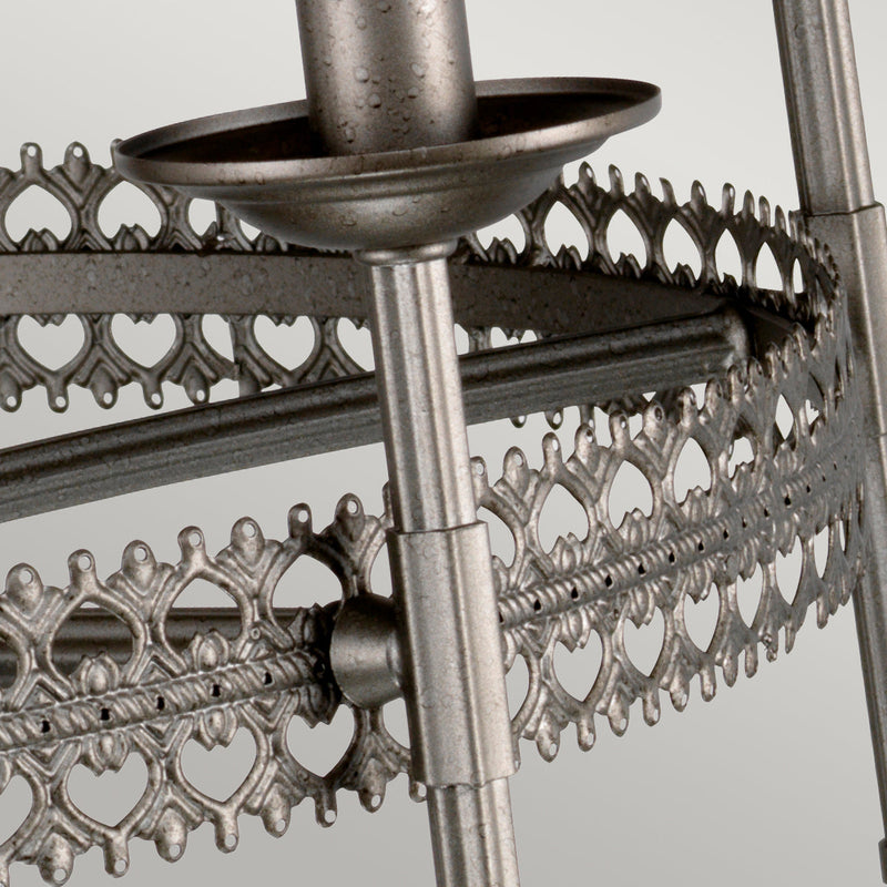 This Elstead Crown 6 light chandelier ceiling light in iron gate finish is traditional and rustic. Featuring a ceiling mount, chain suspension and central rod, with filigree metalwork rim and curving arms attached to tall candle style lights.