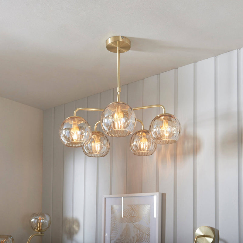 Endon Dimple 5-Light Rectangular Pendant Light in Brass features champagne lustre glass shades, a satin brushed gold finish, and an adjustable drop, making it a refined and stylish addition to contemporary interiors.