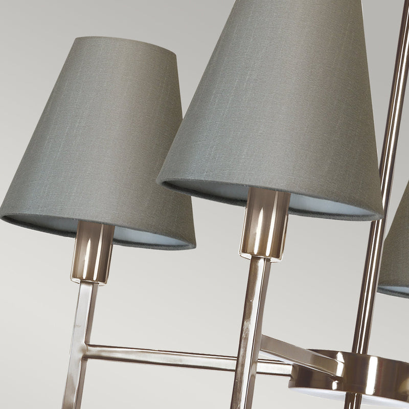 This Elstead Lucerne 4 light chandelier in brushed nickel finish with grey shades is sleek and contemporary. Featuring a ceiling mount, chain suspension, and drop rod, with a lower gallery and four straight arms, with upright stems, bright nickel lamp holders, and grey cone shades. Ideal for a bright and airy dining room, hallway, bedroom, or living room ceiling.