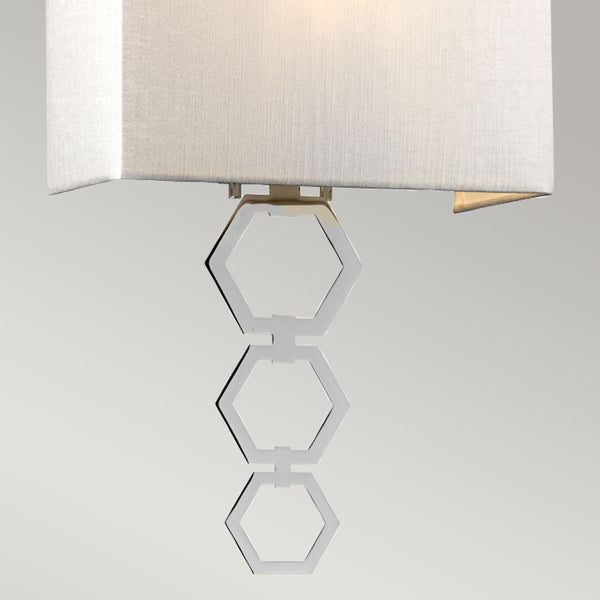 Elstead Ria Medium 1 Light Wall Light in polished chrome with a handcrafted ivory faux silk shade. Features an elegant octagonal finial and dimmable functionality for sophisticated interiors.