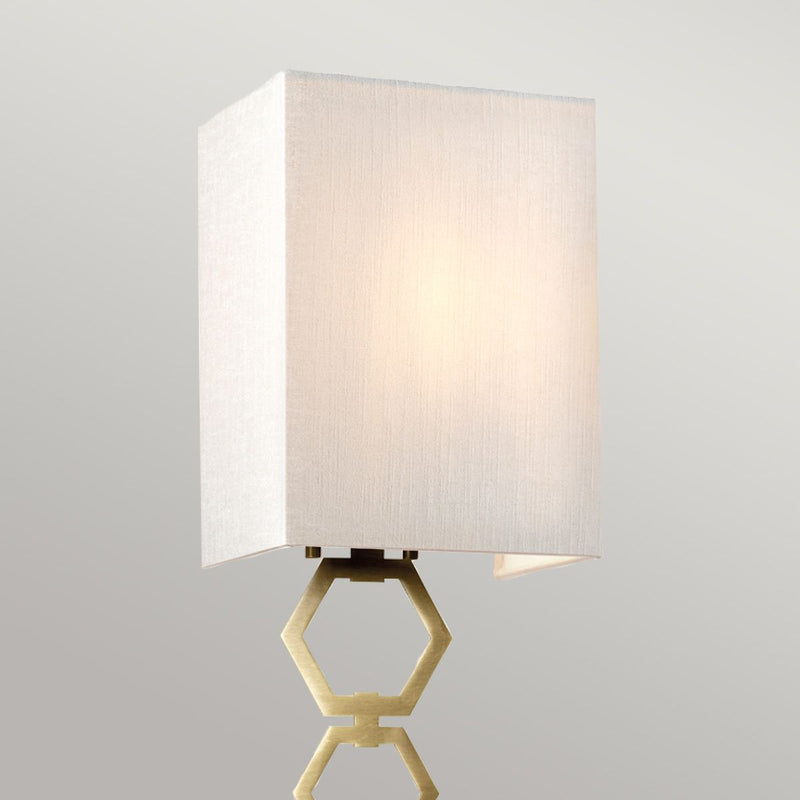 Elstead Ria Small 1 Light Wall Light in aged brass, featuring a handcrafted ivory faux silk shade and an elegant octagonal finial. Compact design with dimmable functionality for stylish interiors.