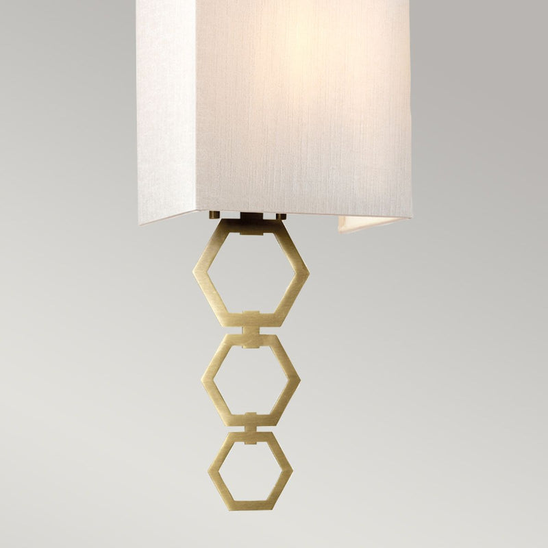 Elstead Ria Small 1 Light Wall Light in aged brass, featuring a handcrafted ivory faux silk shade and an elegant octagonal finial. Compact design with dimmable functionality for stylish interiors.