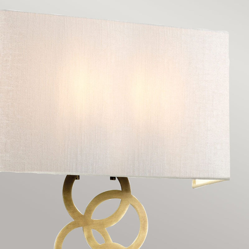 Elstead Rosa Large 2 Light Wall Light in aged brass, featuring a handcrafted ivory faux silk shade and a decorative multi-circle finial. A sophisticated and dimmable lighting solution for elegant interiors.