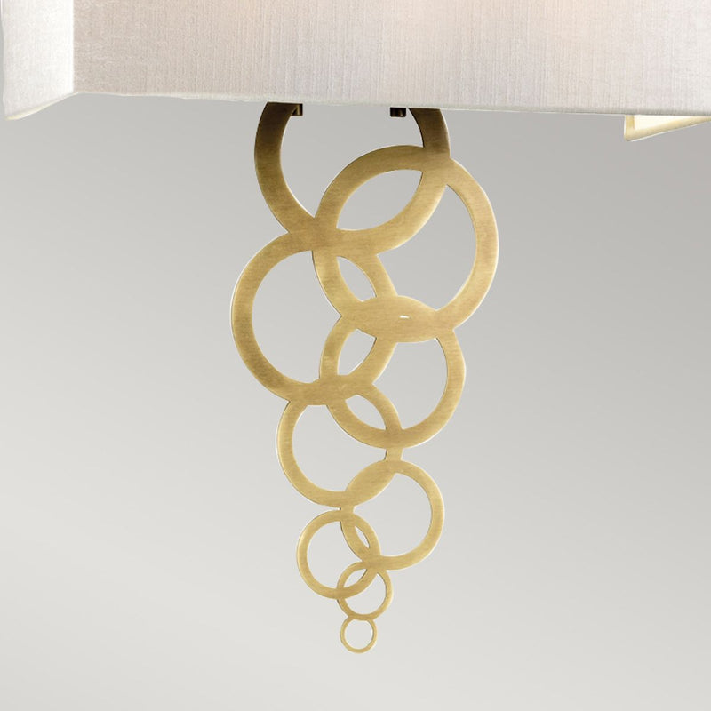 Elstead Rosa Large 2 Light Wall Light in aged brass, featuring a handcrafted ivory faux silk shade and a decorative multi-circle finial. A sophisticated and dimmable lighting solution for elegant interiors.