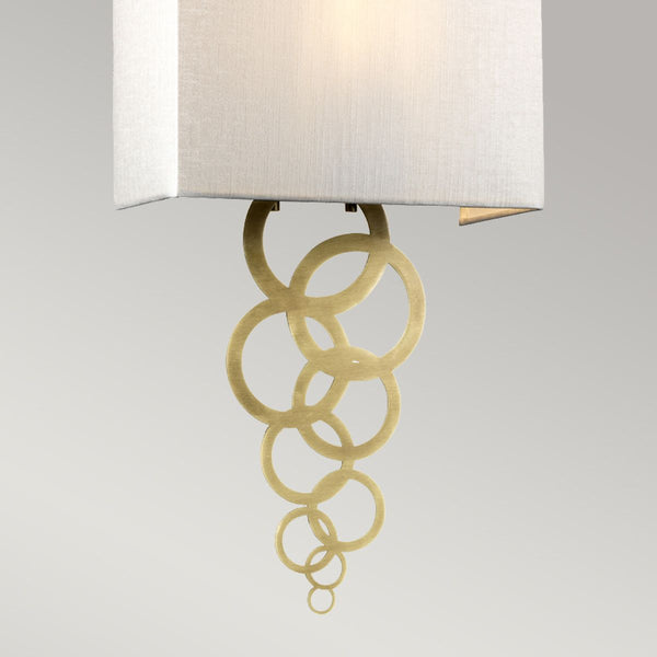 Elstead Rosa Medium 1 Light Wall Light in aged brass, featuring a handcrafted ivory faux silk shade and a multi-circle brass finial. A timeless, elegant lighting fixture for sophisticated interiors.