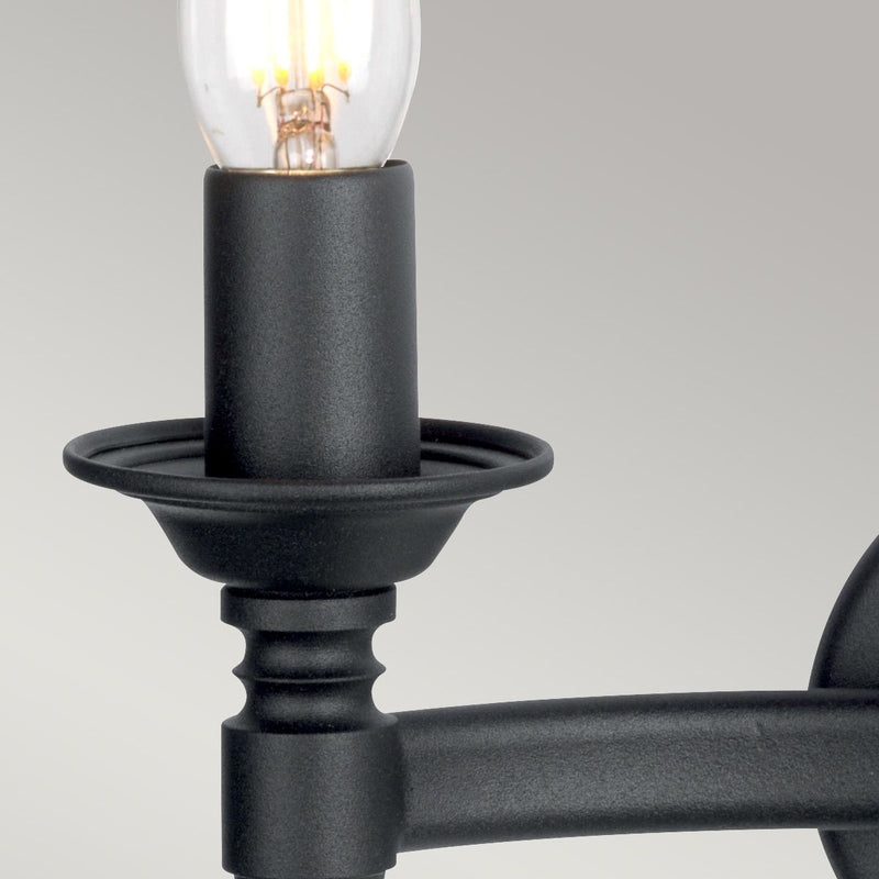 Elstead Saxon 2 Light Wall Light in black wrought iron, featuring decorative beaten metal panels for a medieval-inspired look. A perfect lighting solution for period and rustic interiors.
