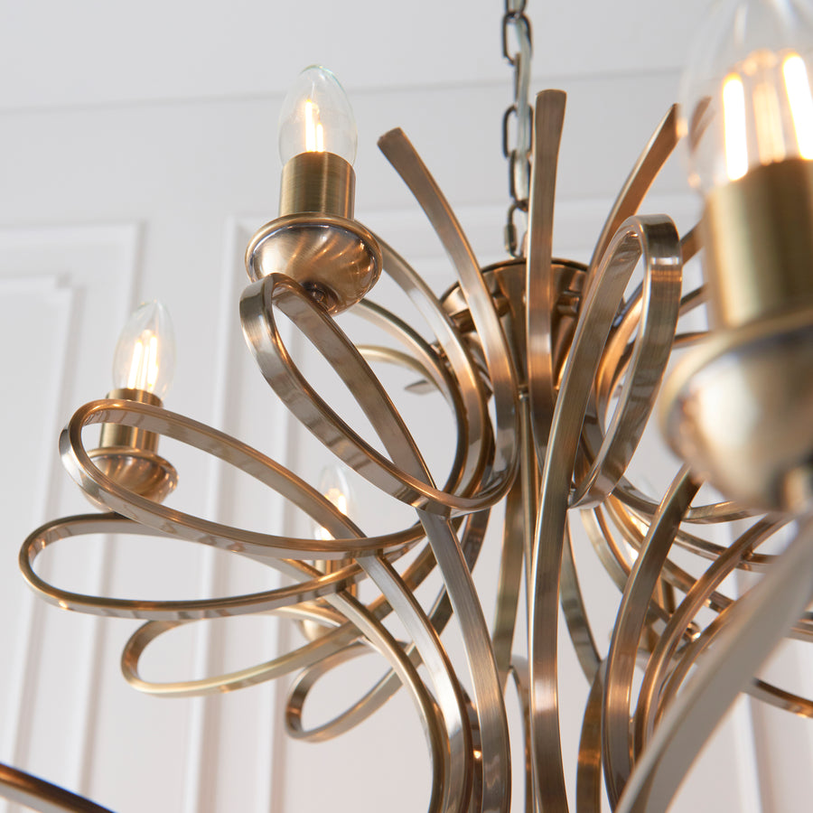 The Penn Lighting Range by Interiors 1900 has established itself as a modern classic 18-light candle chandelier is a decorative range featuring sweeping, curved arms. This impressive 18-light pendant is finished in brass making it a stunning and glamorous addition to any room in your home. 