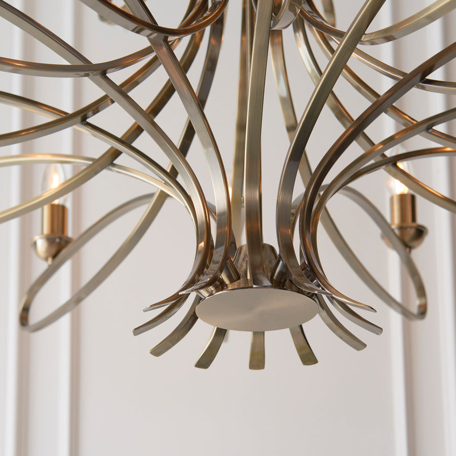 The Penn Lighting Range by Interiors 1900 has established itself as a modern classic 18-light candle chandelier is a decorative range featuring sweeping, curved arms. This impressive 18-light pendant is finished in brass making it a stunning and glamorous addition to any room in your home. 