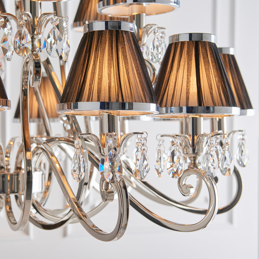 This Oskana 21 light candle chandelier with crystal droplets is from our Oksana nickel range by Interiors 1900. The Oskana Nickel 21-light pendant is an impressive candle chandelier fitting. Finished in a polished nickel plate so it's a perfect piece for hallways, living rooms, and dining rooms.