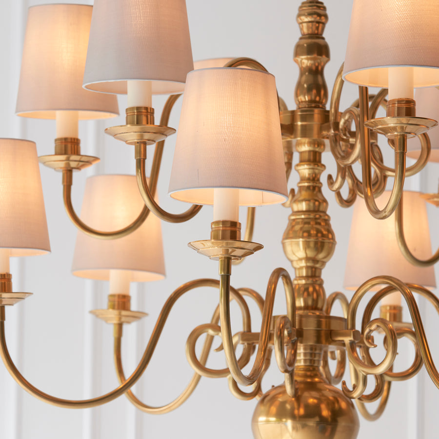 The Chamberlain 12-light pendant is a classic, solid brass candle chandelier with a soft, mellow brass finish and beautifully curved detailing. Made to the highest quality materials using traditional casting techniques, and then hand finished with cream candle drips & fitted marble silk pleated shades to complete the look. Supplied in 2 lengths. 