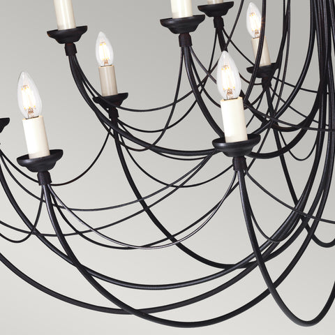 This Elstead Carisbrooke 18 light massive chandelier in Gothic black ironwork is made in Britain and features a circular ceiling mount, with an ornate petal shield and chain link suspension. 