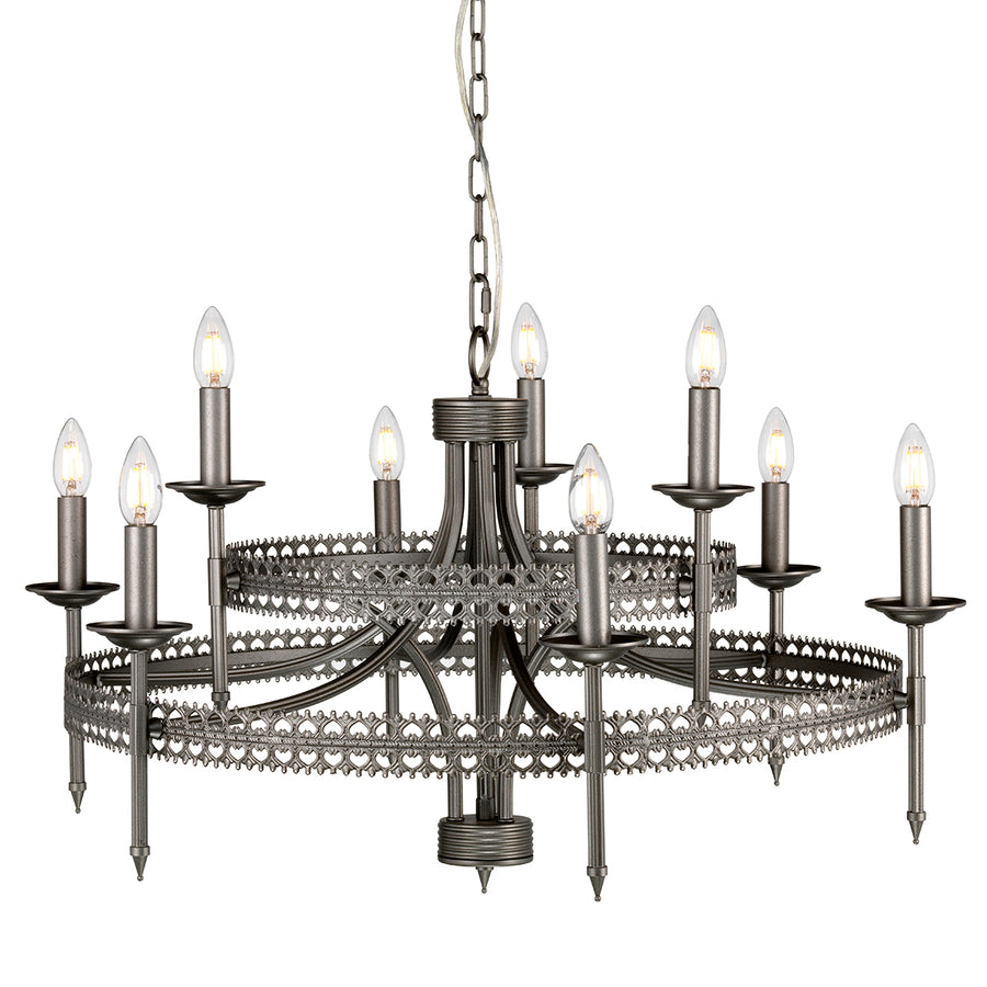 This Elstead Crown 9 light chandelier ceiling light in iron gate finish is traditional and rustic. Featuring a ceiling mount, chain suspension, and central rod, with a large two-tier frame formed by two filigree metalwork circles and curving arms.