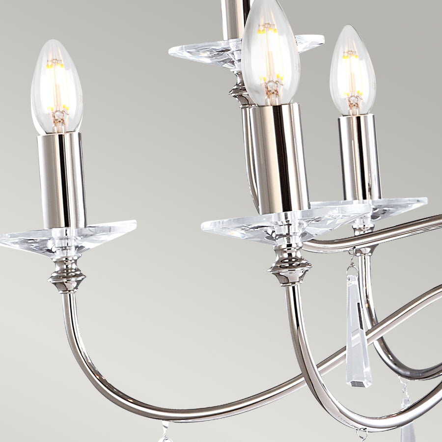 The Elstead Finsbury Park nine-light large chandelier finished in polished nickel, a stunning traditional chandelier, with graceful upswept curved arms. Heavy-cut clear glass sconces, hand-cut glass drops, and matching candle tubes complete this classic light fitting. 