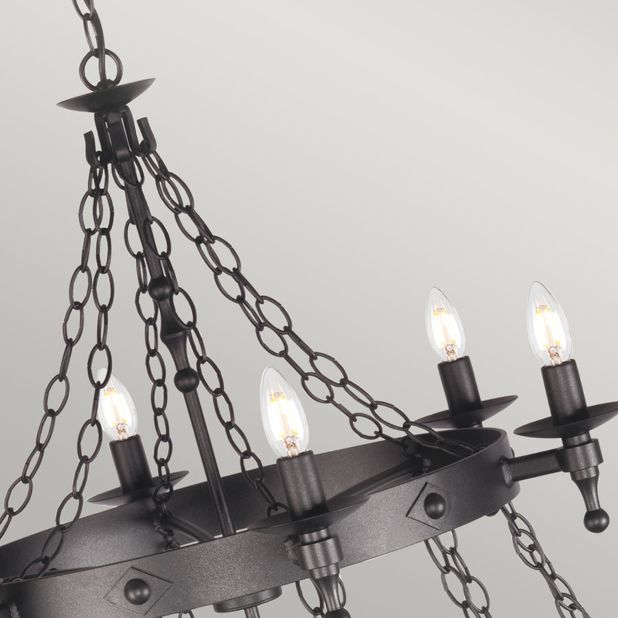 The Elstead Warwick 18 light extra large ironwork chandelier in graphite finish is handmade in England to the highest standards. This huge cartwheel chandelier features a heavy central drop rod suspended from matching chains and two cartwheel frames at different levels. Twelve candle lights on the bottom tier and six on the top, with metal candle pans and matching candle tubes.