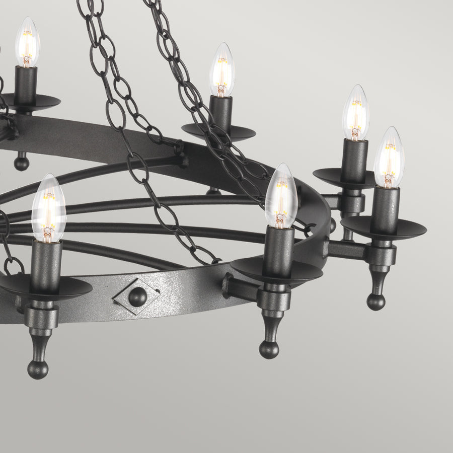 The Elstead Warwick 18 light extra large ironwork chandelier in graphite finish is handmade in England to the highest standards. This huge cartwheel chandelier features a heavy central drop rod suspended from matching chains and two cartwheel frames at different levels. Twelve candle lights on the bottom tier and six on the top, with metal candle pans and matching candle tubes.